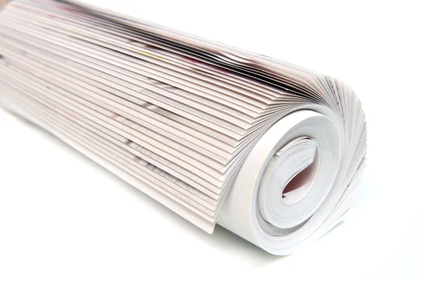 Rolled up magazine on white — Stock Photo, Image