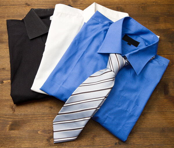 Close up of stacked shirts with tie.