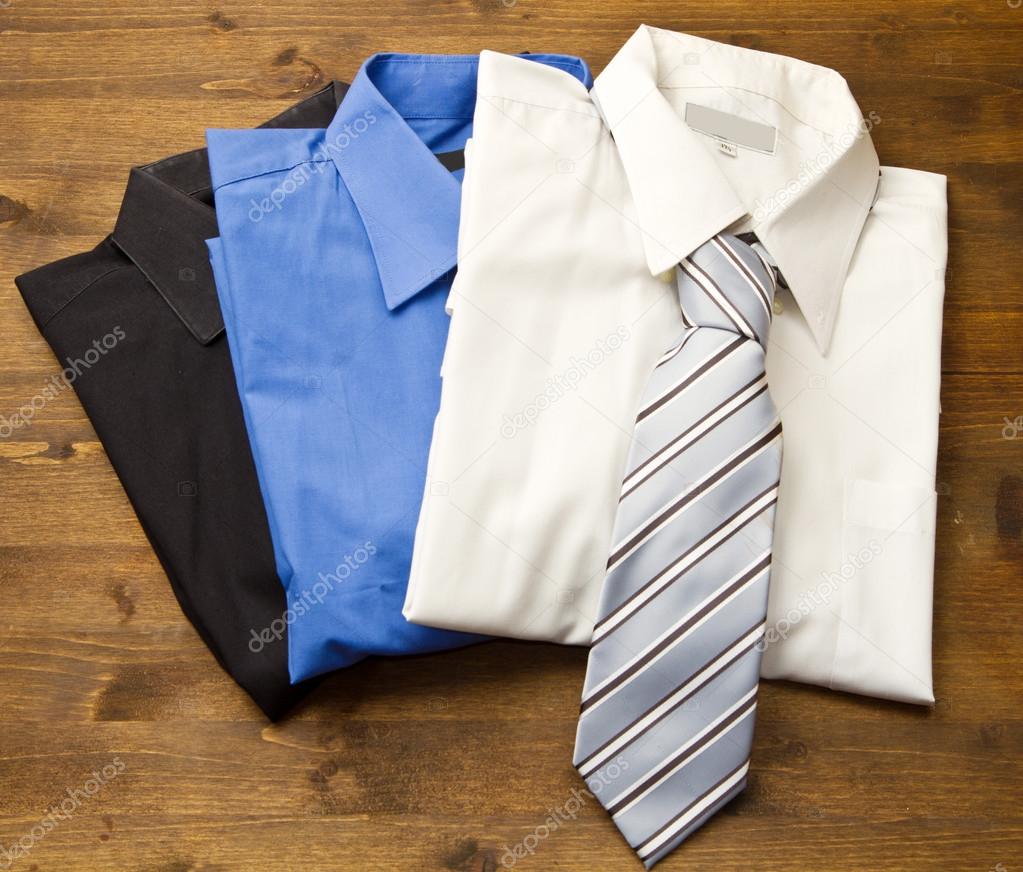 Close up of stacked shirts with tie.