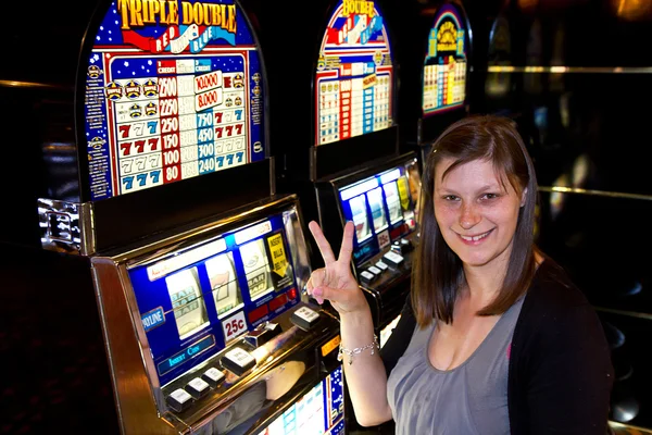 Woman in Casino on a slot machine Stock Photo by ©lsantilli 27038057