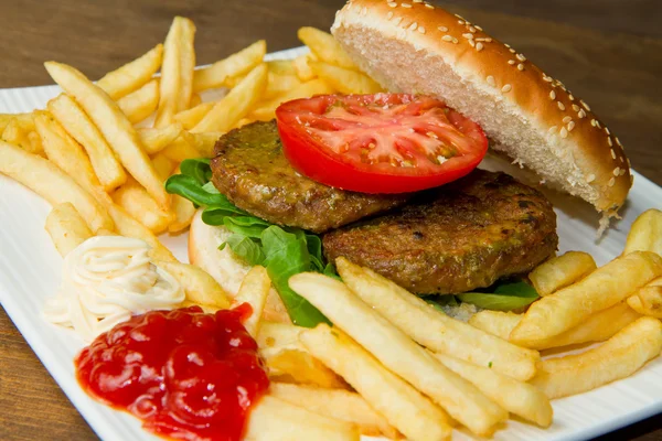 Hamburger bun with fries — Stock Photo, Image