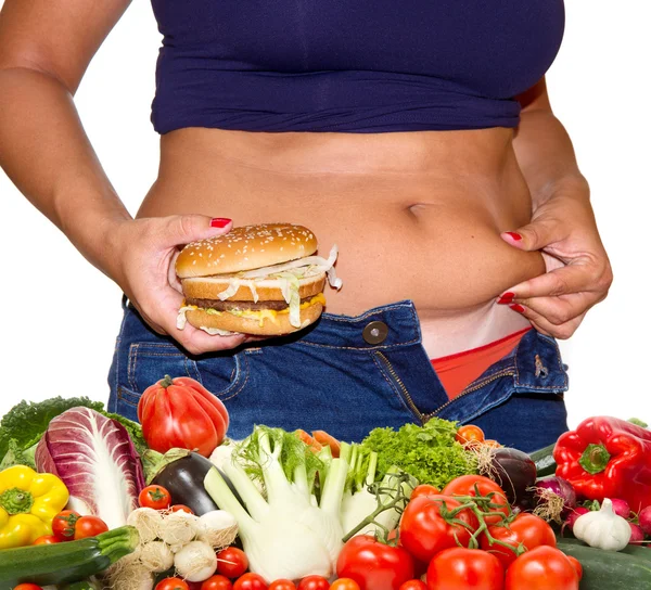 Fat woman with hamburger and vegetables — Stock Photo, Image