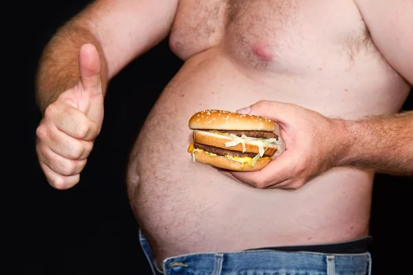 Fat man met hamburger — Stockfoto