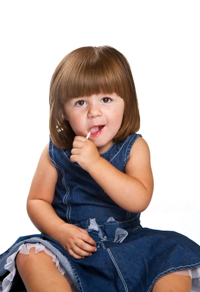 Pretty little girl with a lollipop — Stock Photo, Image