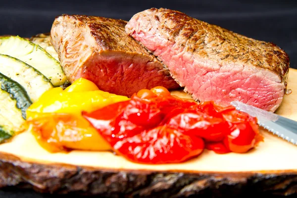 Deliciosos filetes de ternera sobre mesa de madera — Foto de Stock