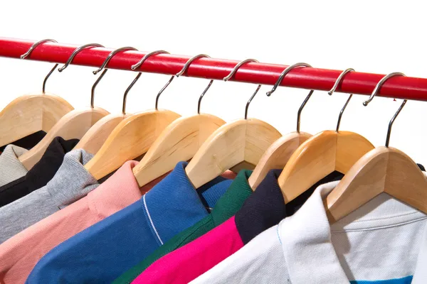 Lots of T-shirts on hangers — Stock Photo, Image