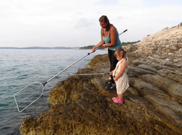 Mère et fille pêchant sur la mer — Photo