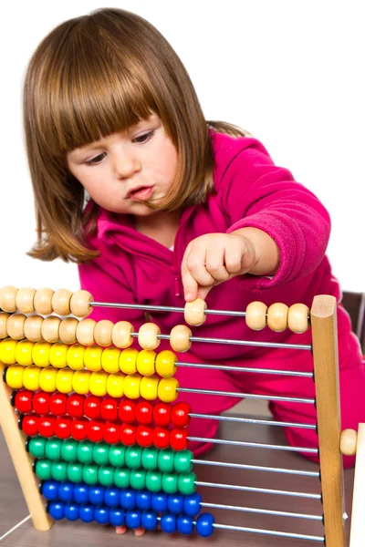 Lovely little girl learning with abacus — Stock Photo, Image