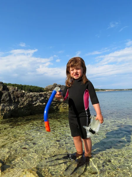 Portrait of happy girl with wetsuit, masks and snorkels at the s — Stock Photo, Image