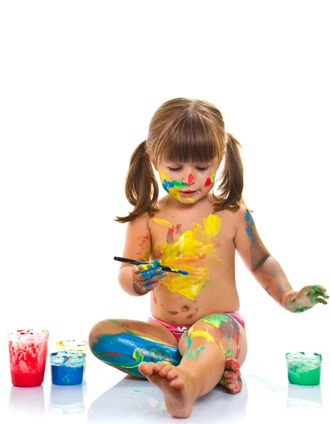 Little girl painting with paintbrush and colorful paints — Stock Photo, Image
