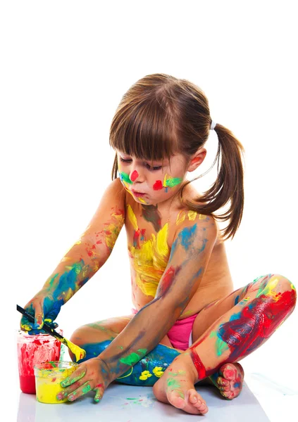 Little girl painting with paintbrush and colorful paints — Stock Photo, Image