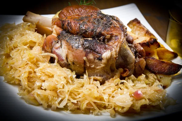 Pork knuckle baked with  sauerkraut — Stock Photo, Image