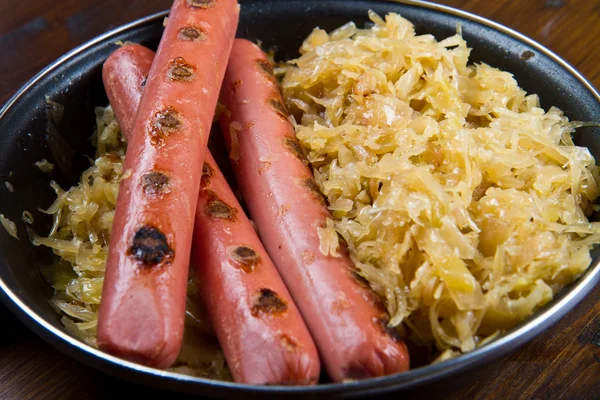 Roasted wurstel with  sauerkraft and beer — Stock Photo, Image