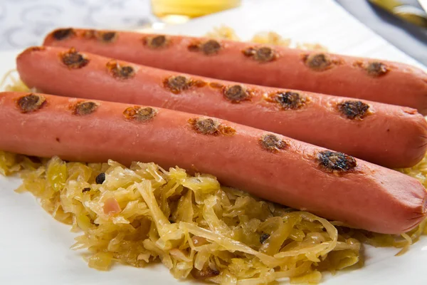 Dish with roasted wurstel and sauerkraft — Stock Photo, Image