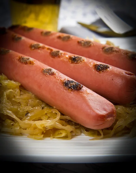 Dish with roasted wurstel and sauerkraft — Stock Photo, Image