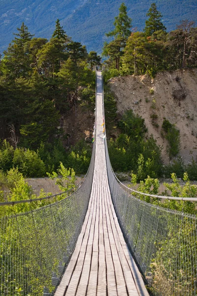 Hängebrücke über saisonalen Fluss lizenzfreie Stockbilder