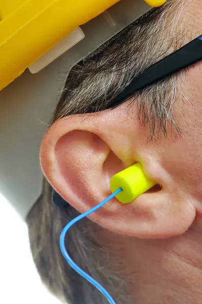 Tapón amarillo en el oído — Foto de Stock