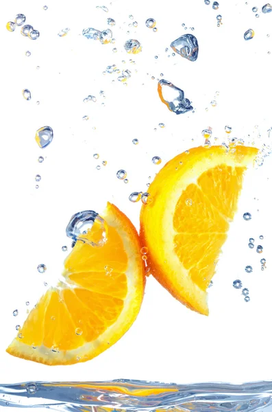 Orange slice splashing into water — Stock Photo, Image