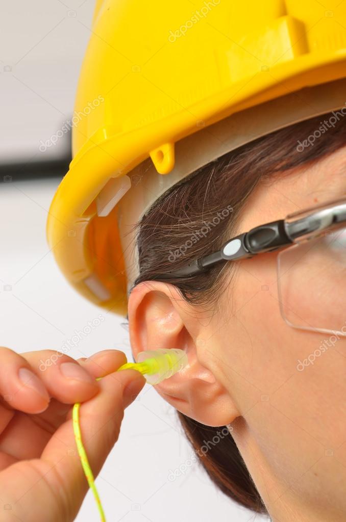 Woman with protective ear plugs