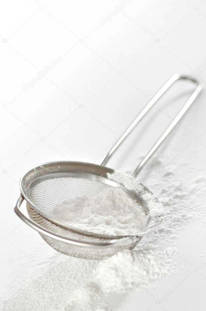 powdered sugar in a metal strainer