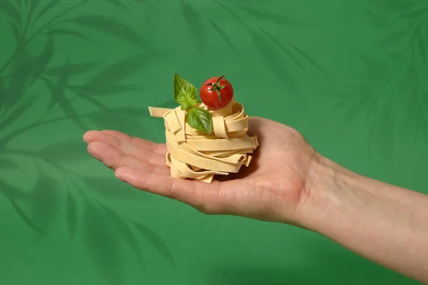 Pasta Tagliatelle Nest Hand Isolated Green Background — Stock Fotó