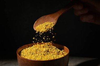 Raw Amorphous Pollen On A Wooden Spoon in Studio