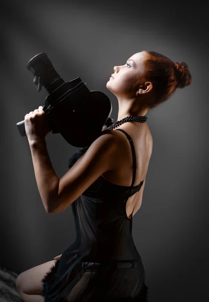 Woman with old camera in studio — Stock Photo, Image