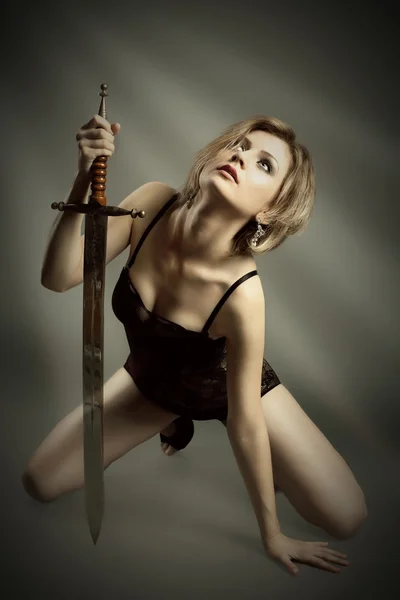 Beauty blond woman with sword — Stock Photo, Image