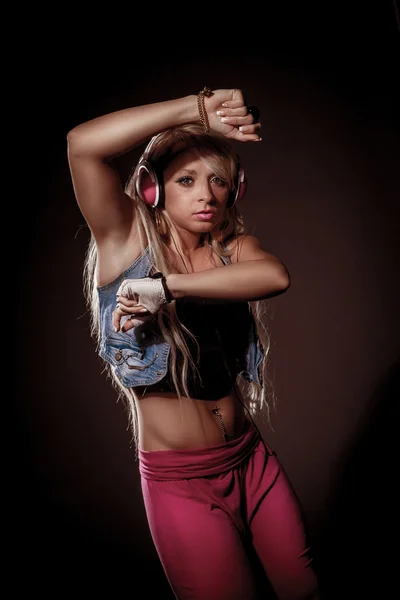 Sexy blonde woman dancing with headphones — Stock Photo, Image