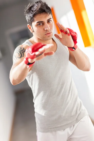 Boxer avec gants rouges dans une salle de gym — Photo