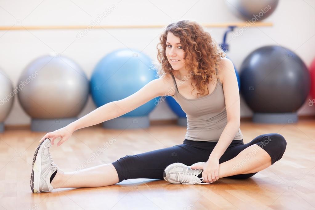 Young woman doing stretching exercise