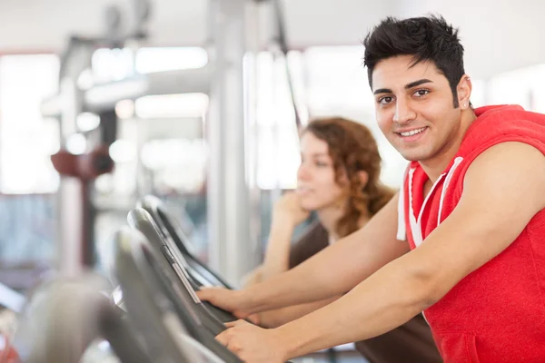 Man is doing workout on a bicycle at the gym — Stock Photo, Image