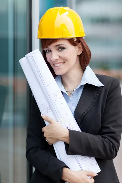Portrait of female constructor with blueprints — Stock Photo, Image