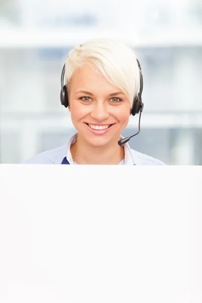 Young support assistant behind white message board — Stock Photo, Image