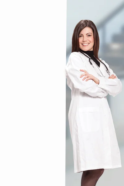 Smiling female doctor with message board — Stock Photo, Image