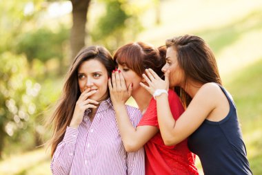 Three woman are whispering clipart
