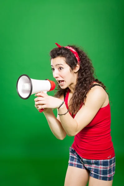 Young woman screaming through megaphone — Stock Photo, Image