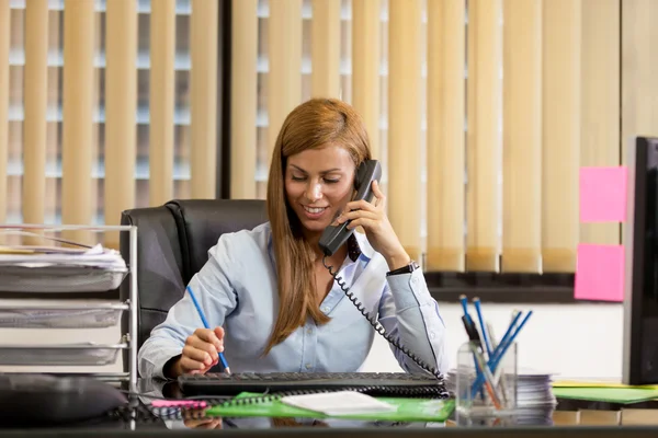 Businesswoman is phoning in the office — Stock Photo, Image