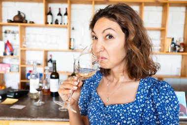 Woman sniffs and tasting bad wine. The concept of loss of sense of smell and long covid clipart