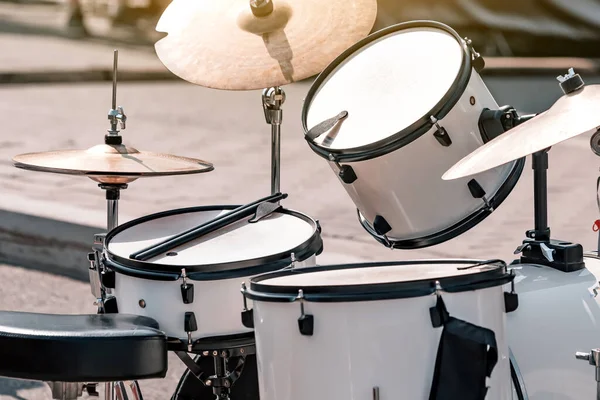 play the drum set outdoors. Music school and learning concept