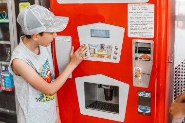 18 Ağustos 2021, Ufa, Rusya: Otomattan maden veya soda almak. Satıcısı olmayan modern otomatik ticaret