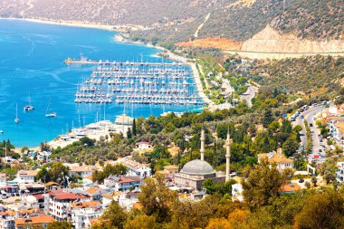 Charming view of seaside resort town of Kas in Turkey. Romantic harbour with yacht marina and mosque with minarets clipart