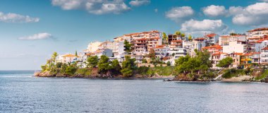 Yunanistan 'ın Sithonia, Halkidiki kentindeki Neos Marmaras tatil beldesindeki evler ve villalar Akdeniz' deki dağ yamacında. Gayrimenkul ve kentsel kalkınma kavramı