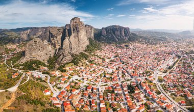 Panoramic aerial view of the city of Kalabaka near the famous monasteries on the tops of stone pillars in Meteora. The concept of tourist accommodation and real estate in Greece. clipart