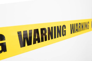 Sarı uyarı bandı izole edildi ve beyaz arka planda kesildi. Risk ve kaza kavramı