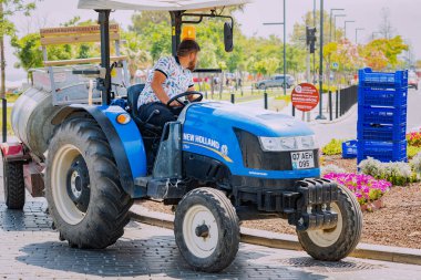 04 June 2022, Antalya, Turkey: Municipal and city services workers plant, care for and water flowers in a flowerbed
