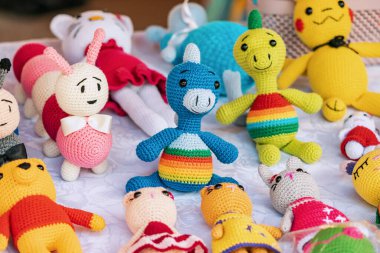 Various knitted funny toys for children are sold at the hand made market