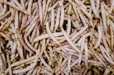 Green and white fresh pod peas are sold at the farmer's market