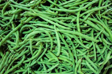 Green and white fresh pod peas are sold at the farmer's market