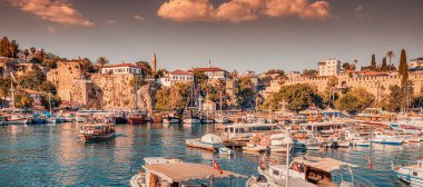 21 June 2022, Antalya, Turkey: Panoramic view of the picturesque bay with marina port with yachts and cruise tourist ships near the old town of Kaleici in Antalya. Turkish Riviera and resort paradise